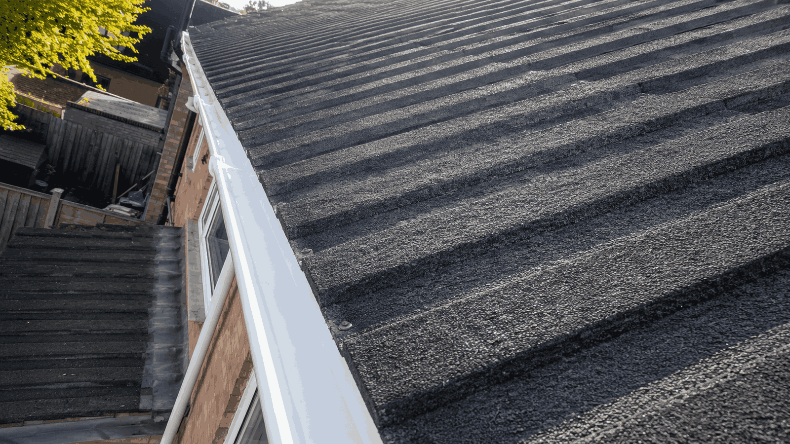 After gutter cleaning - clear gutters showing documented maintenance for insurance purposes